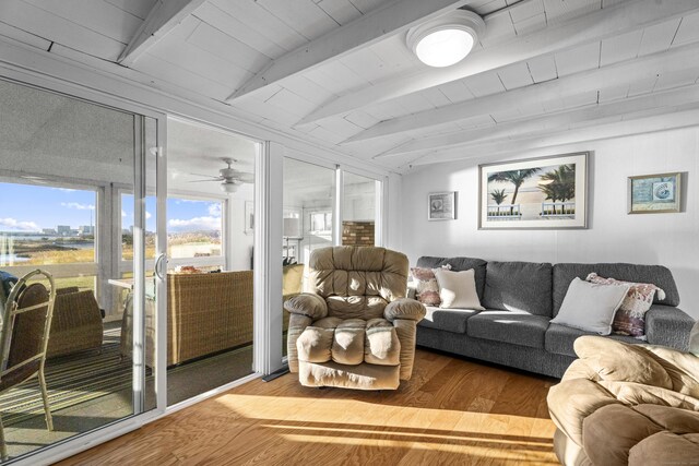 living room with lofted ceiling with beams, ceiling fan, wooden ceiling, and hardwood / wood-style flooring