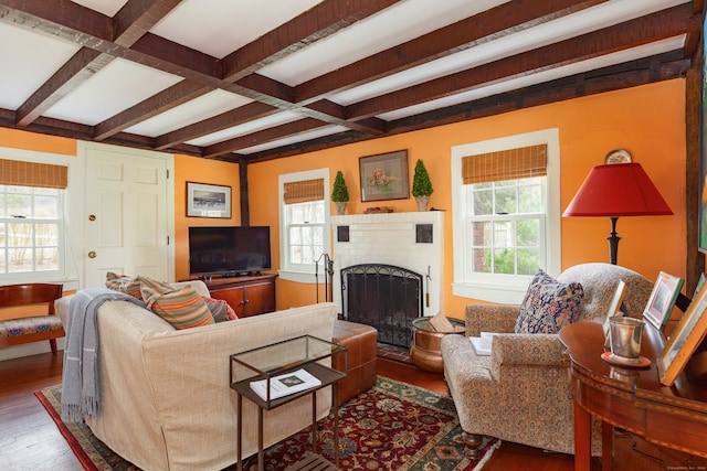 living room with beamed ceiling, coffered ceiling, hardwood / wood-style floors, and a fireplace