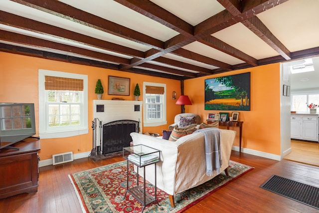 living room with dark wood-type flooring, beam ceiling, and coffered ceiling