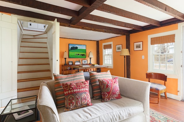 living room featuring hardwood / wood-style flooring and beamed ceiling