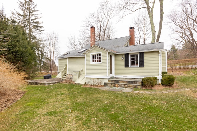 back of house with a lawn