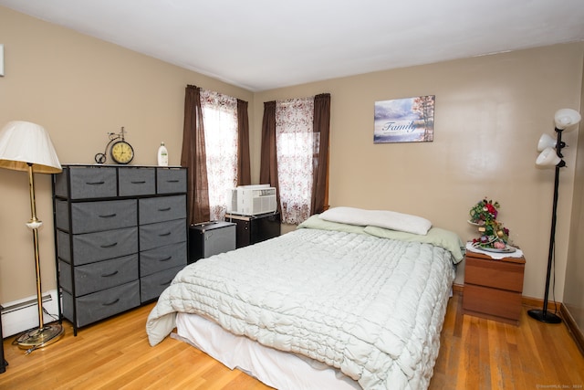 bedroom featuring hardwood / wood-style floors and cooling unit