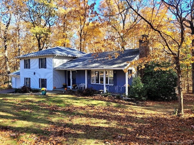 view of front of house featuring a front yard and covered porch