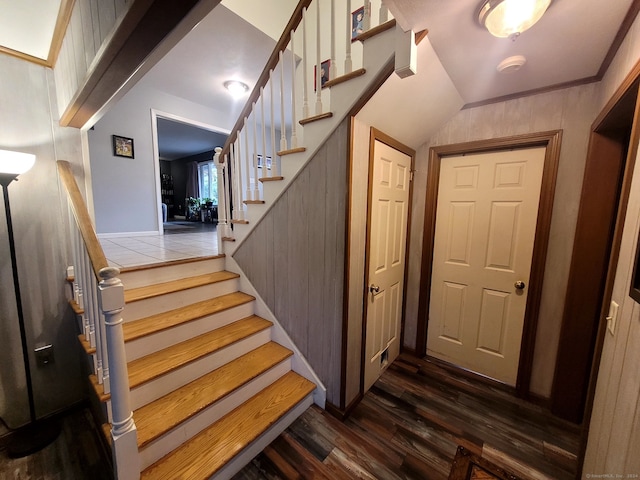 stairs featuring lofted ceiling and hardwood / wood-style flooring