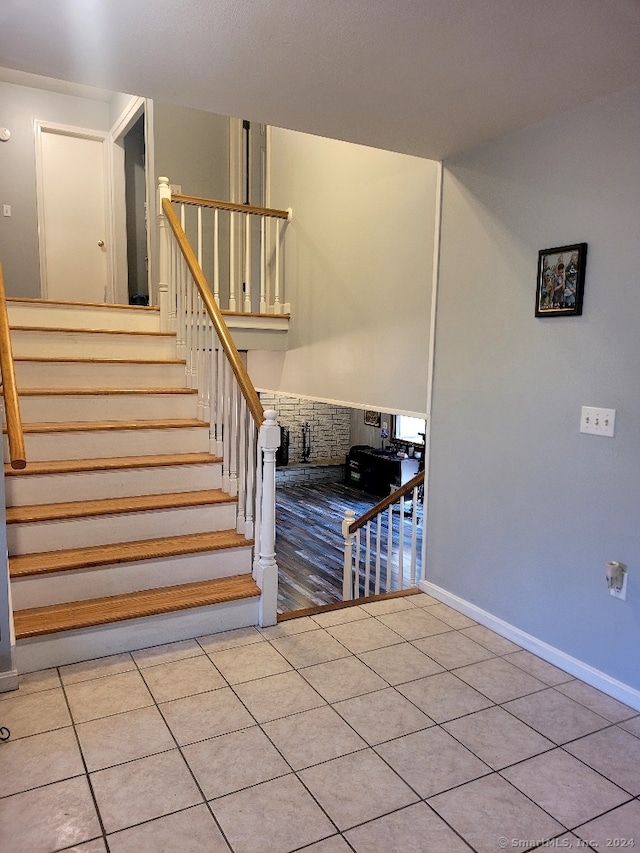 staircase featuring tile patterned floors