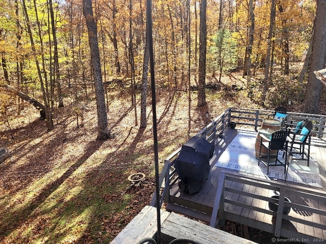 wooden deck with a grill