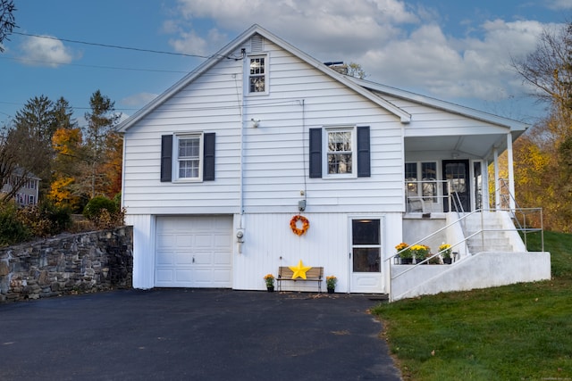 view of side of property with a garage and a yard