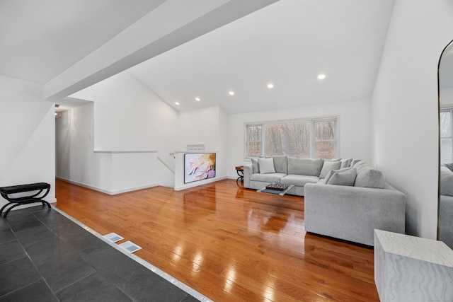 living room featuring dark hardwood / wood-style floors and lofted ceiling