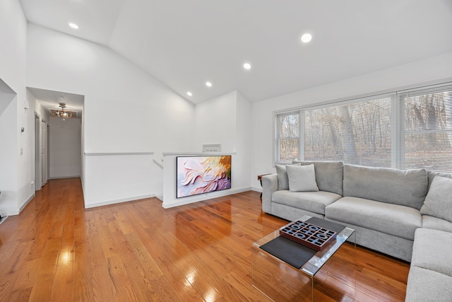 living room with light wood-type flooring and lofted ceiling