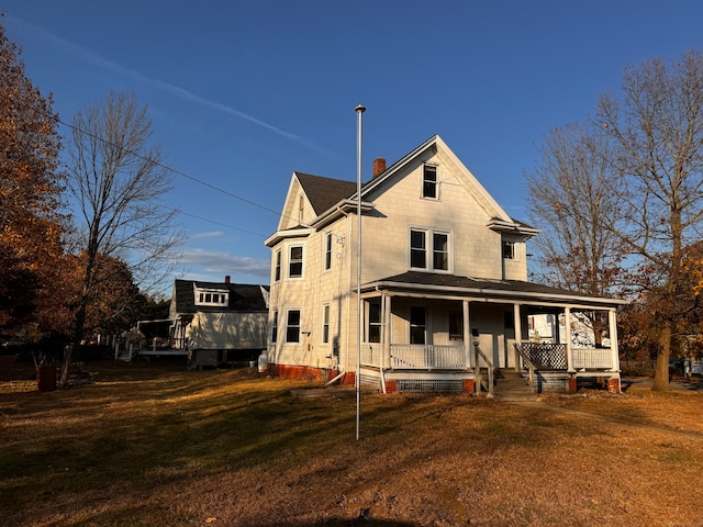 exterior space featuring a porch and a yard