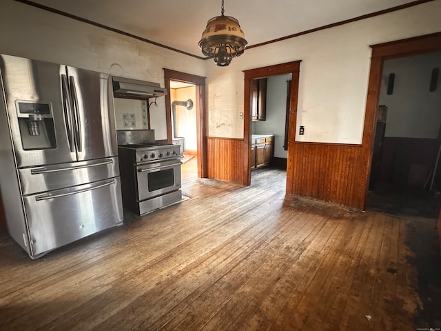 kitchen featuring ornamental molding, hardwood / wood-style floors, stainless steel appliances, and wood walls