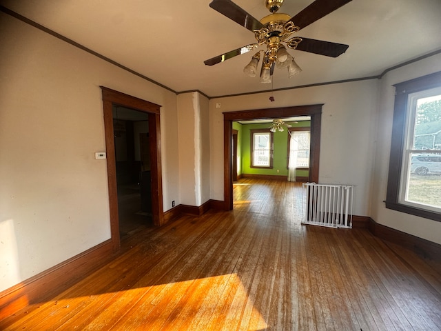 spare room featuring ceiling fan, a wealth of natural light, and dark hardwood / wood-style floors