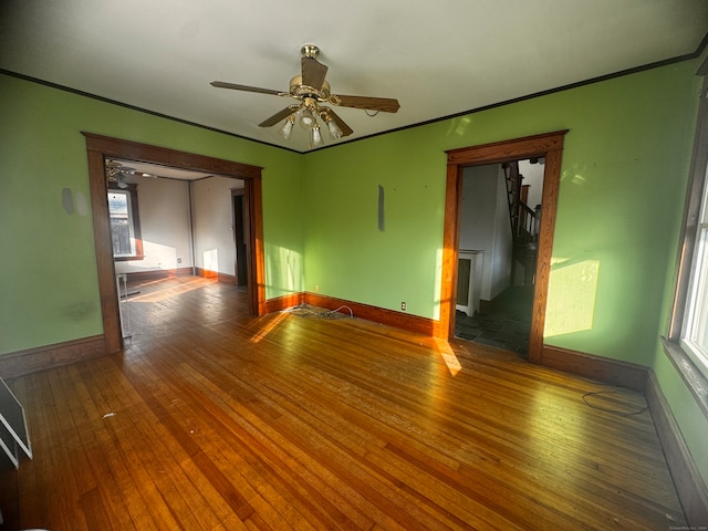 empty room with wood-type flooring and ceiling fan