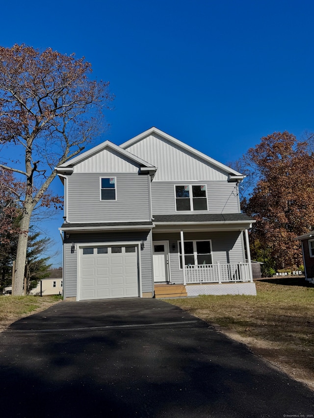 view of front of property featuring a garage and covered porch