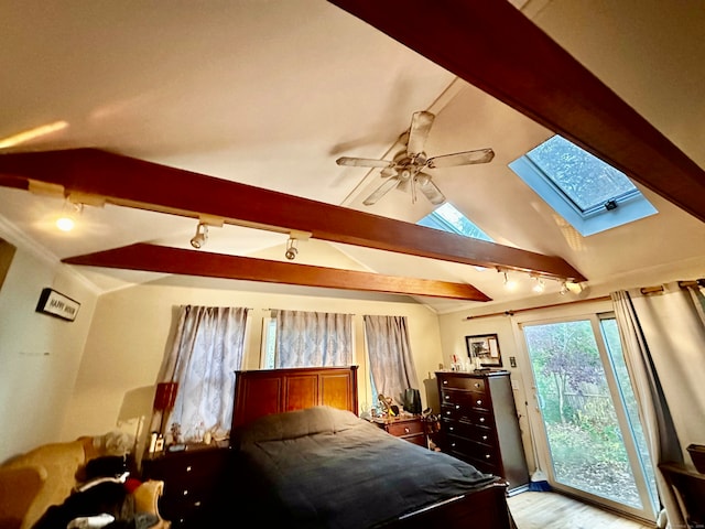 bedroom featuring access to exterior, ceiling fan, light hardwood / wood-style flooring, track lighting, and vaulted ceiling with skylight