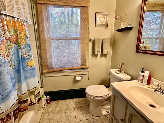 full bathroom featuring toilet, vanity, tile patterned floors, and a healthy amount of sunlight