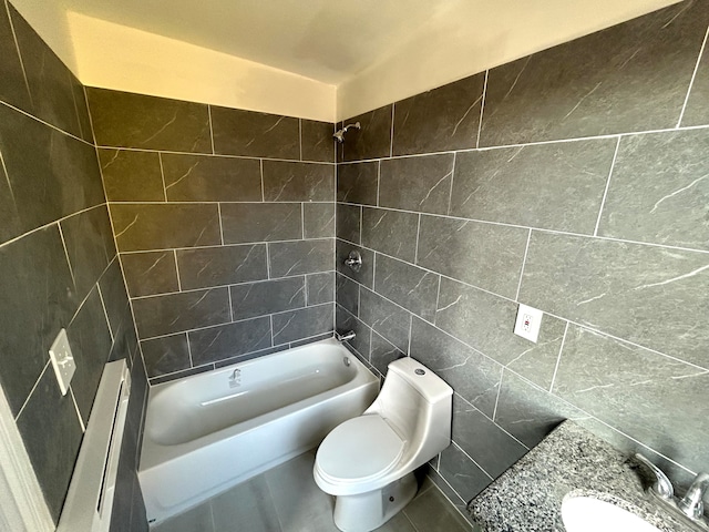 full bathroom with tile walls, tile patterned floors, tiled shower / bath combo, sink, and toilet