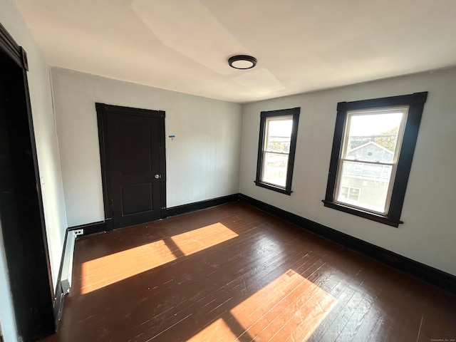 empty room with hardwood / wood-style floors