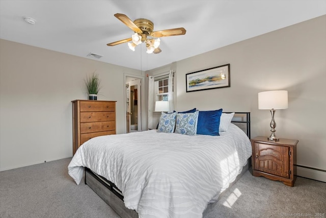 carpeted bedroom featuring a closet, a spacious closet, ceiling fan, and a baseboard radiator