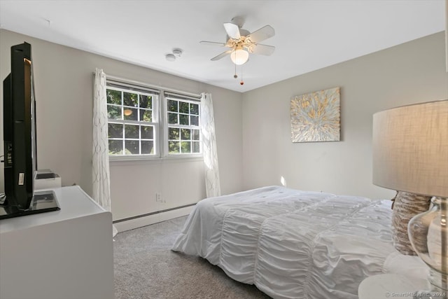 bedroom with ceiling fan, baseboard heating, and light carpet