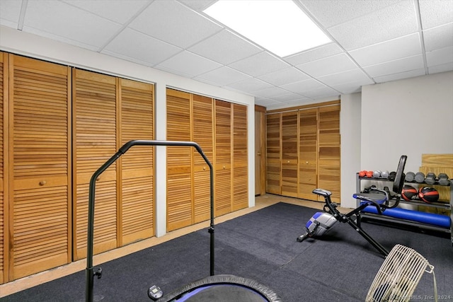 exercise area with a paneled ceiling