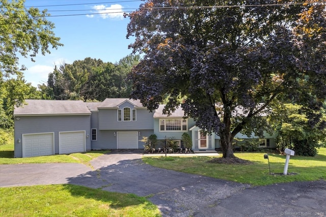 view of front of home with a front lawn and a garage