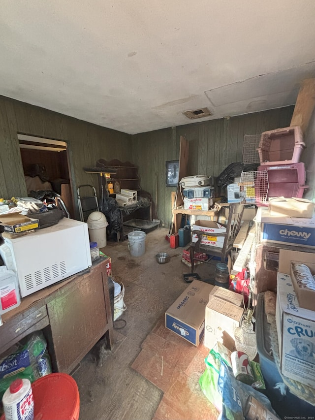 miscellaneous room featuring wooden walls