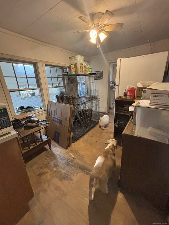 interior space with ceiling fan