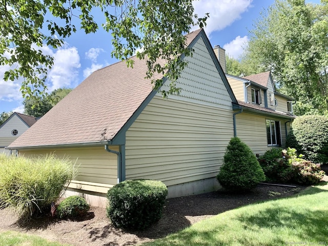 view of property exterior featuring a lawn