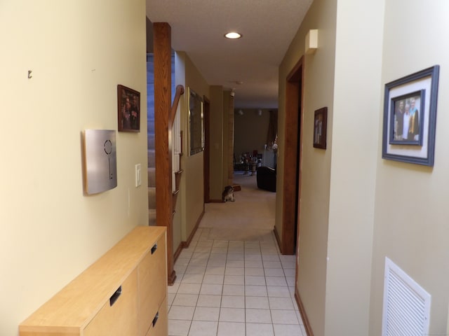 hallway featuring light colored carpet