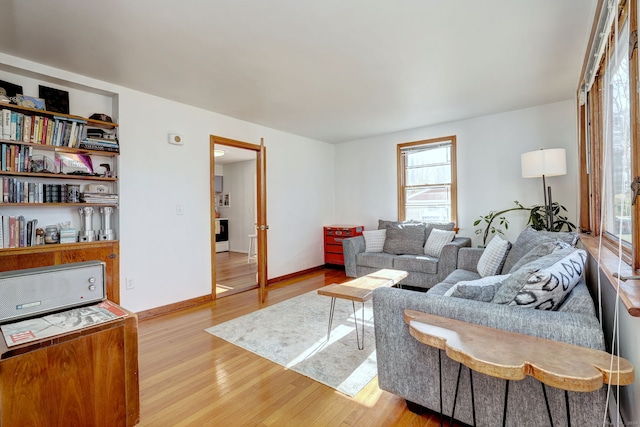 living room with a wealth of natural light and wood-type flooring