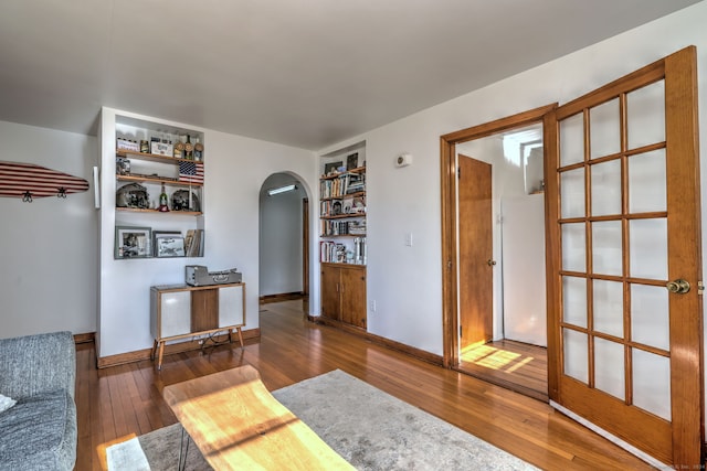 interior space with built in features and dark wood-type flooring