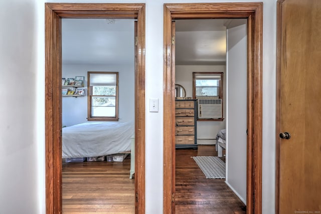 hall with dark hardwood / wood-style floors, a baseboard radiator, and cooling unit