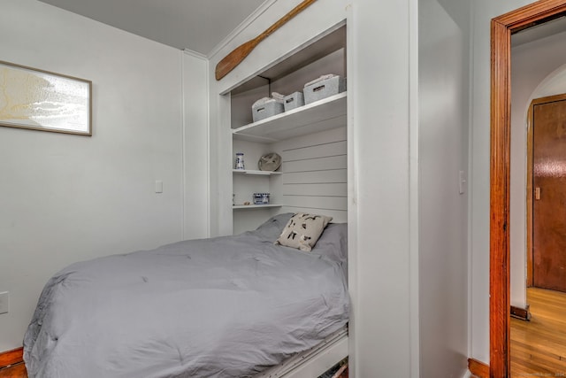 bedroom featuring hardwood / wood-style floors and a closet