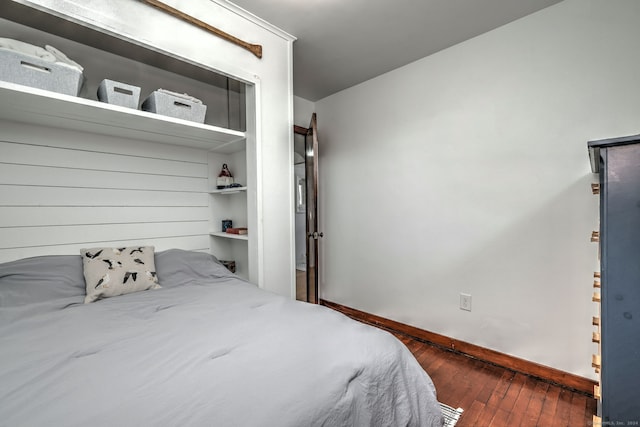 bedroom with dark hardwood / wood-style floors