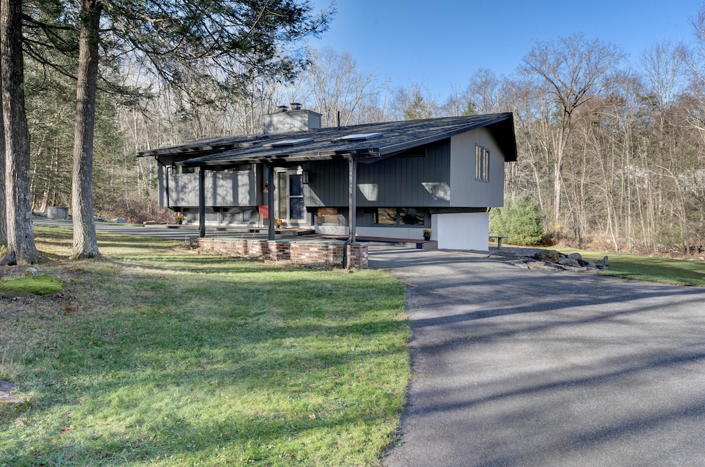 view of front of house with a garage and a front lawn