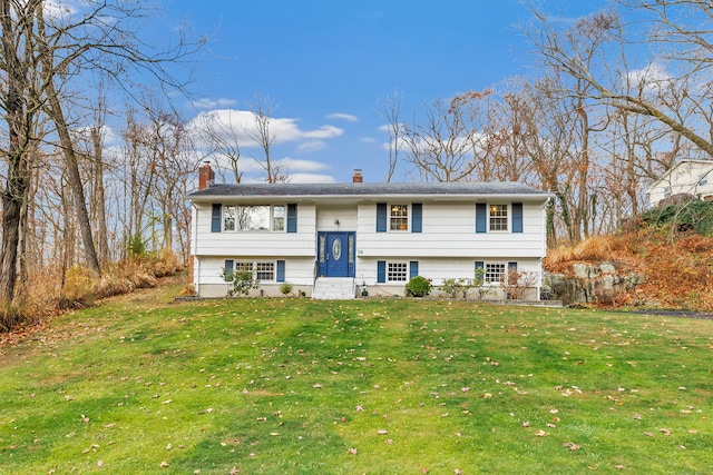 raised ranch with a front yard