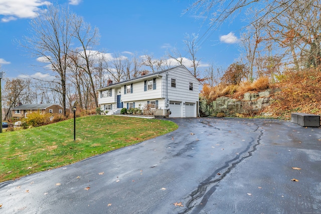 view of front of property with a garage and a front lawn