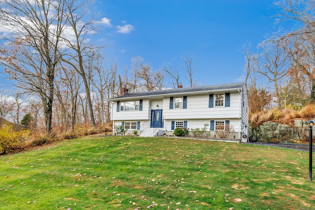 split foyer home with a front lawn