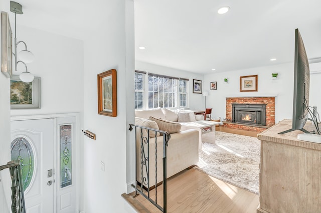 living room featuring a fireplace and light hardwood / wood-style flooring