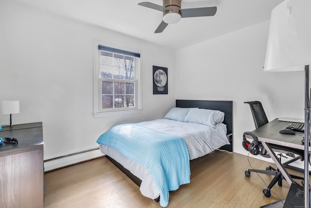 bedroom with light hardwood / wood-style flooring, ceiling fan, and a baseboard heating unit