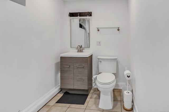 bathroom featuring tile patterned floors, vanity, and toilet