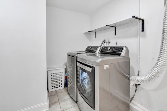 washroom featuring light tile patterned floors and washing machine and dryer