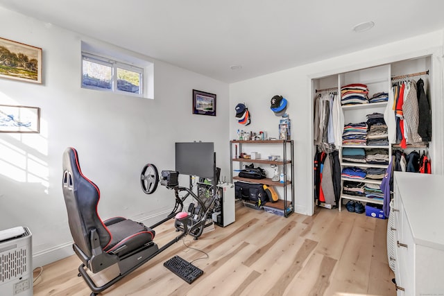 workout area with light hardwood / wood-style floors