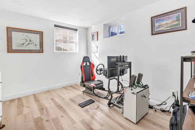 exercise room with light hardwood / wood-style floors