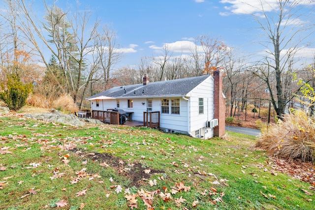 rear view of house featuring a yard