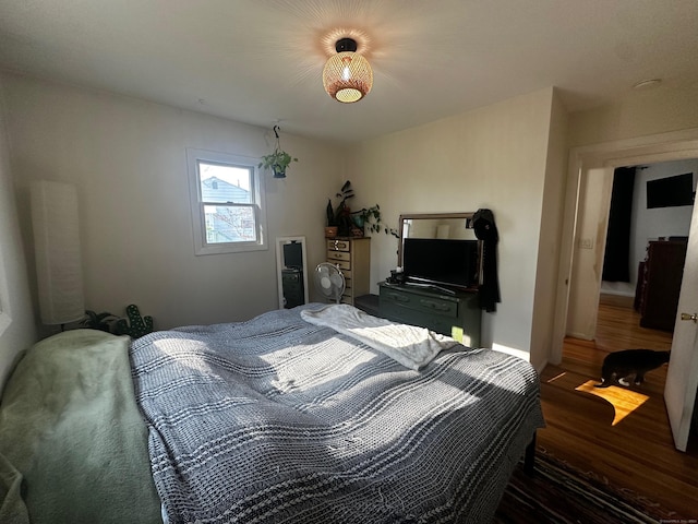 bedroom with dark hardwood / wood-style flooring