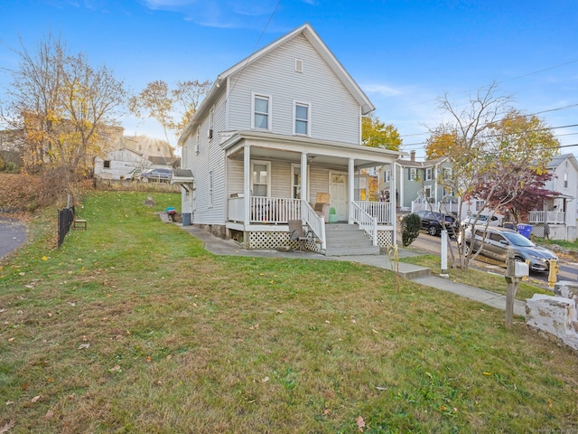 view of front of home with a front lawn and a porch