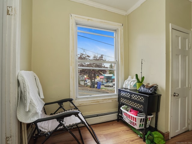 sitting room featuring hardwood / wood-style flooring and ornamental molding