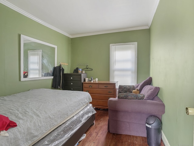 bedroom with dark hardwood / wood-style floors and ornamental molding